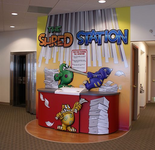 A room with a sign that says the shred station