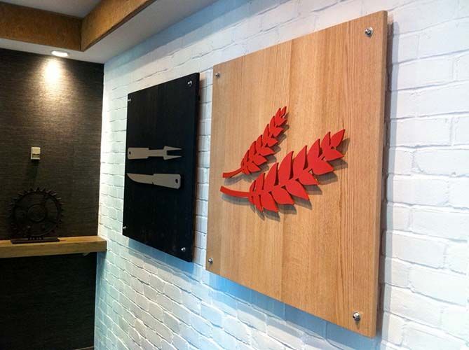 A brick wall with a wooden sign on it