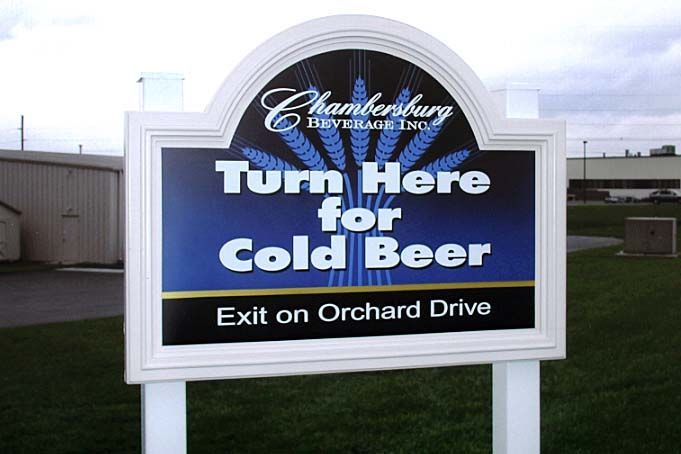 A sign that says turn here for cold beer