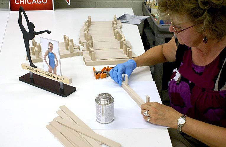 A woman is sitting at a table with a sign that says chicago on it