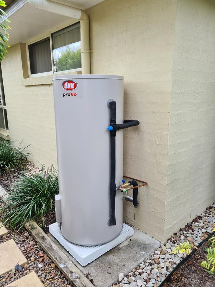 A White Water Heater Is Sitting on The Side of A House — 24/7 HOT H2O in Valdora, QLD