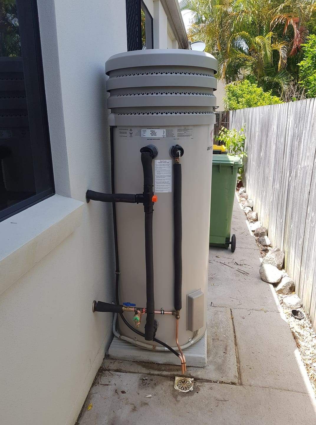 A Large Water Heater Is Sitting on The Side of A Building — 24/7 HOT H2O in Valdora, QLD