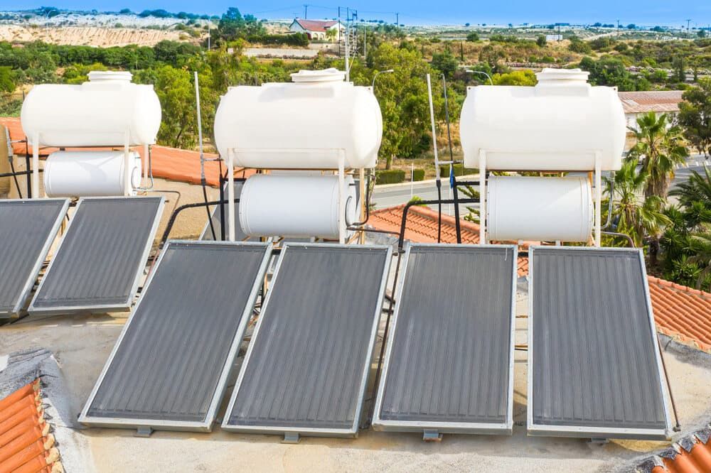 A Row of Solar Panels and Water Tanks on Top of A Roof  — 24/7 HOT H2O in Peregian Springs, QLD