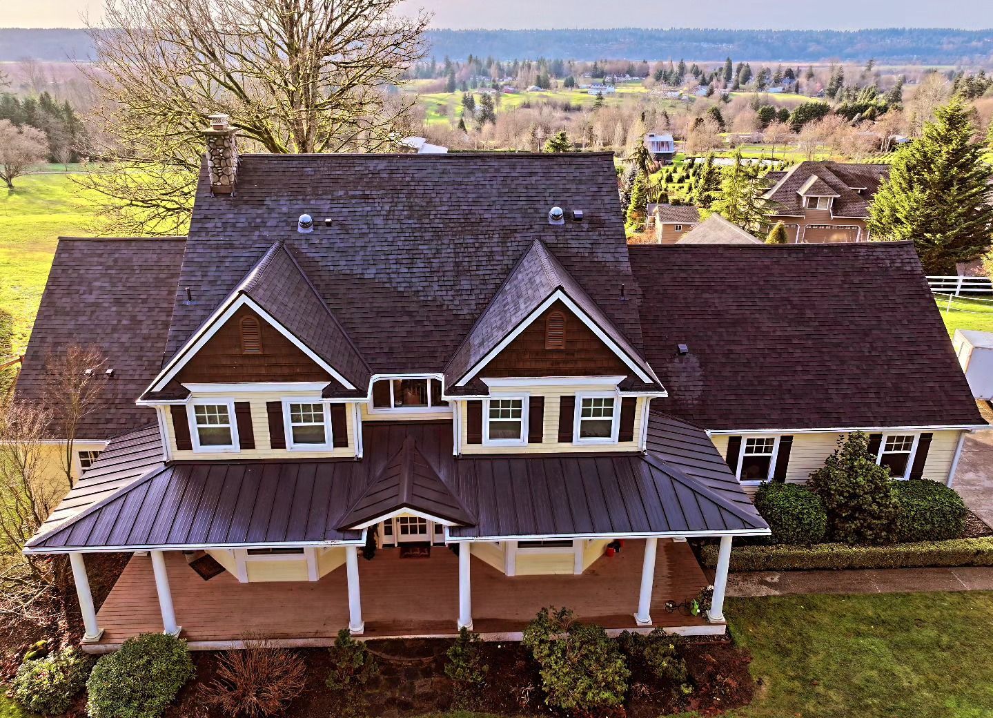 An aerial view of a large house with a large porch.