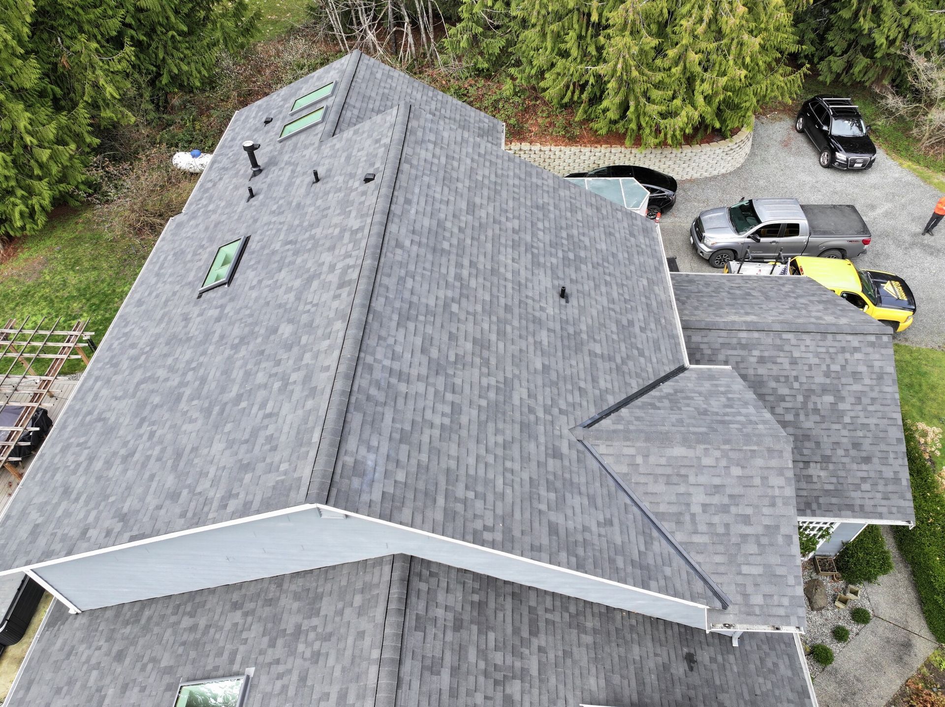 An aerial view of a large house with a gray roof.