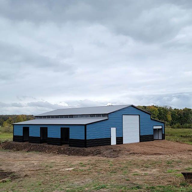 Blue Steel Barn In A Land— Potterville, Monroe & Gaylord, MI — Just Wood & Steel Sales & Design Center LLC