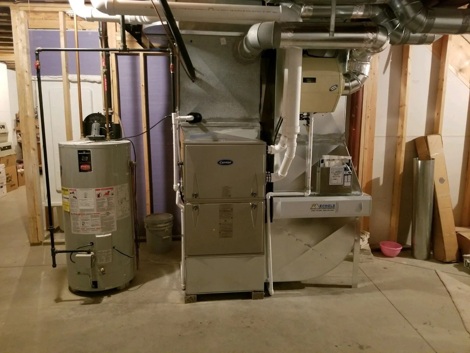 A basement with a water heater and a furnace.