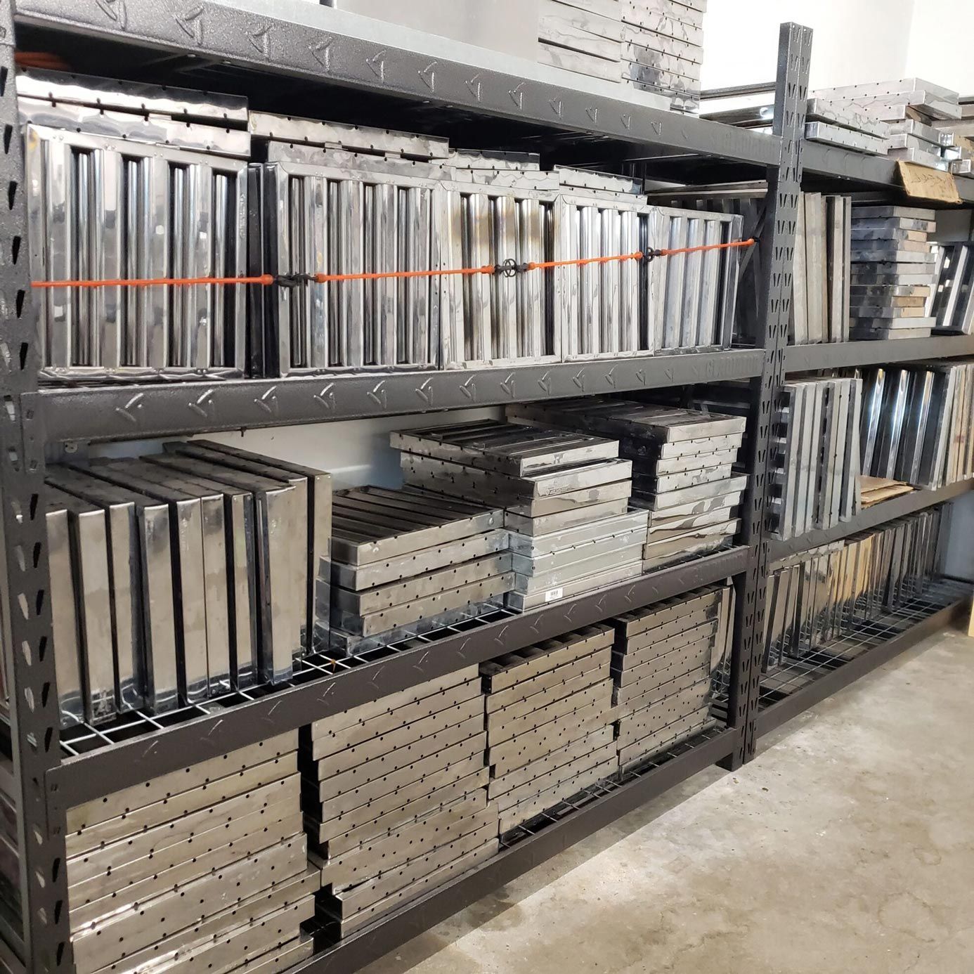A warehouse filled with lots of stainless steel shelves.