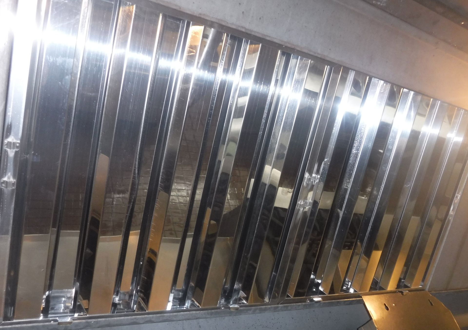 A kitchen with a hood that has a light on it