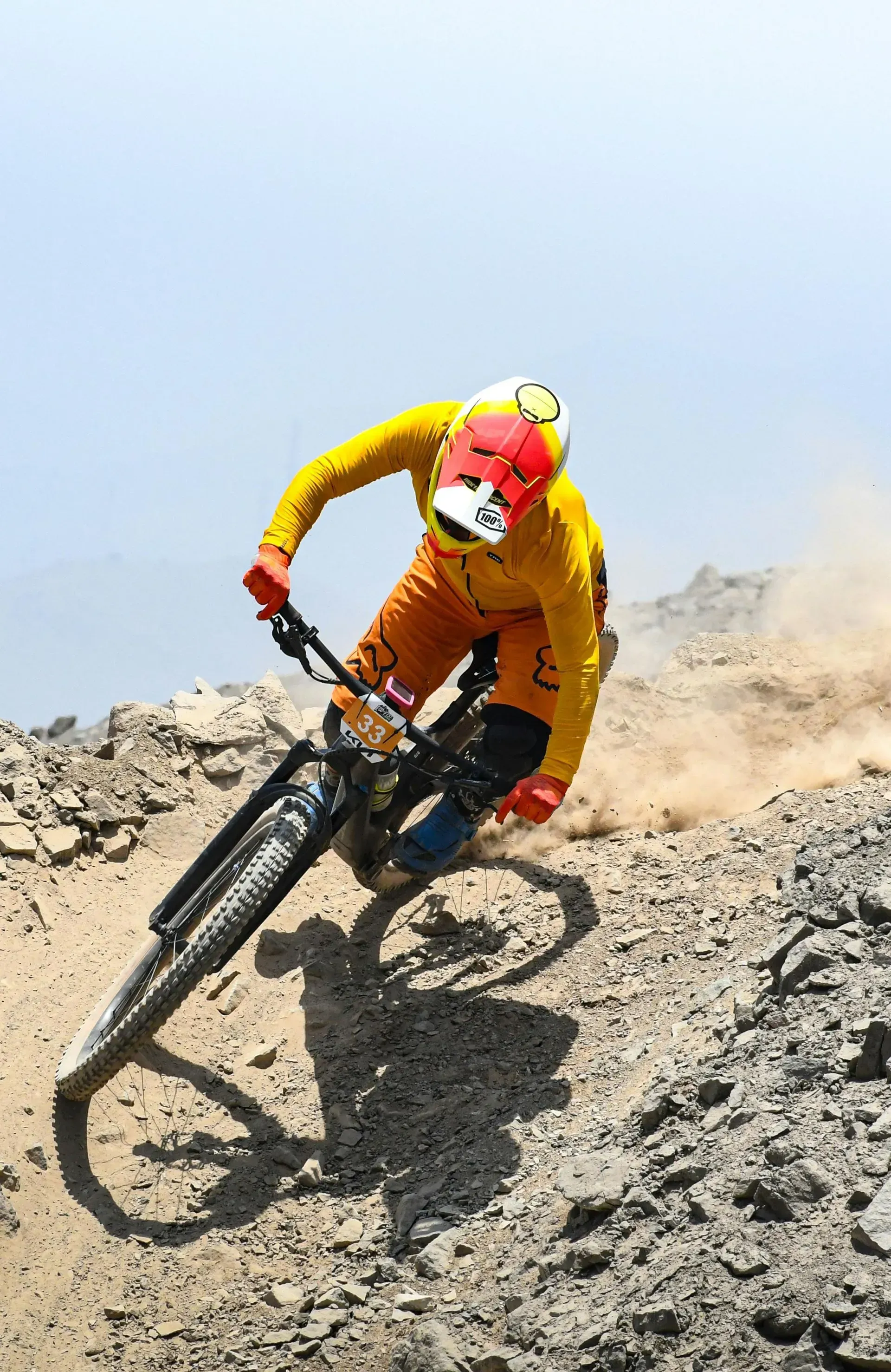 A person is riding a mountain bike down a dirt road.