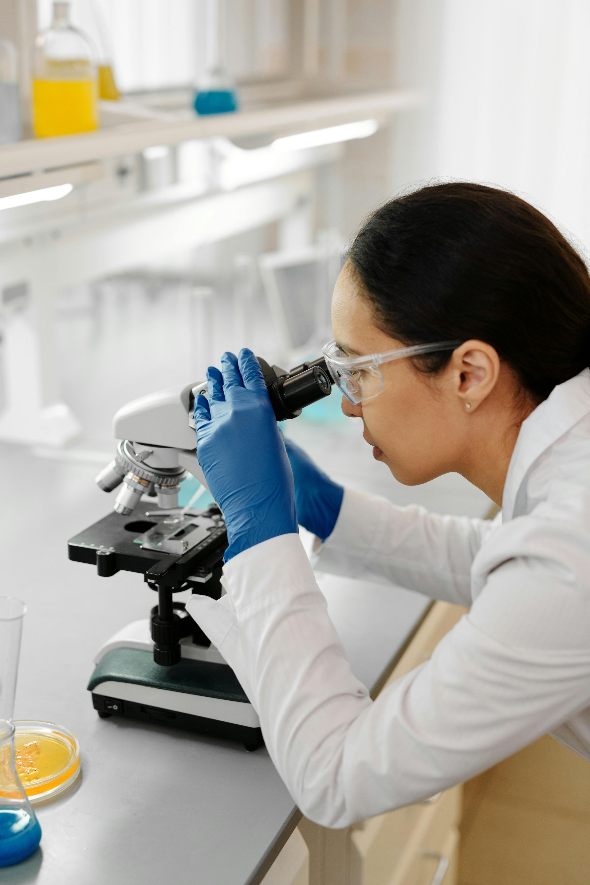 A scientist is looking through a microscope in a laboratory.