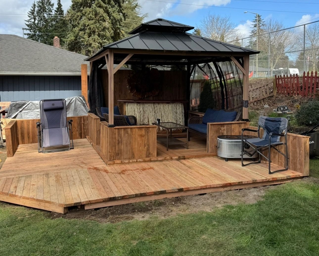 A person holding a baby up in the air indoors near a window, baby smiling.