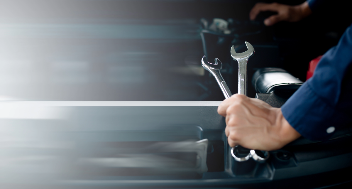 A mechanic holding spanners
