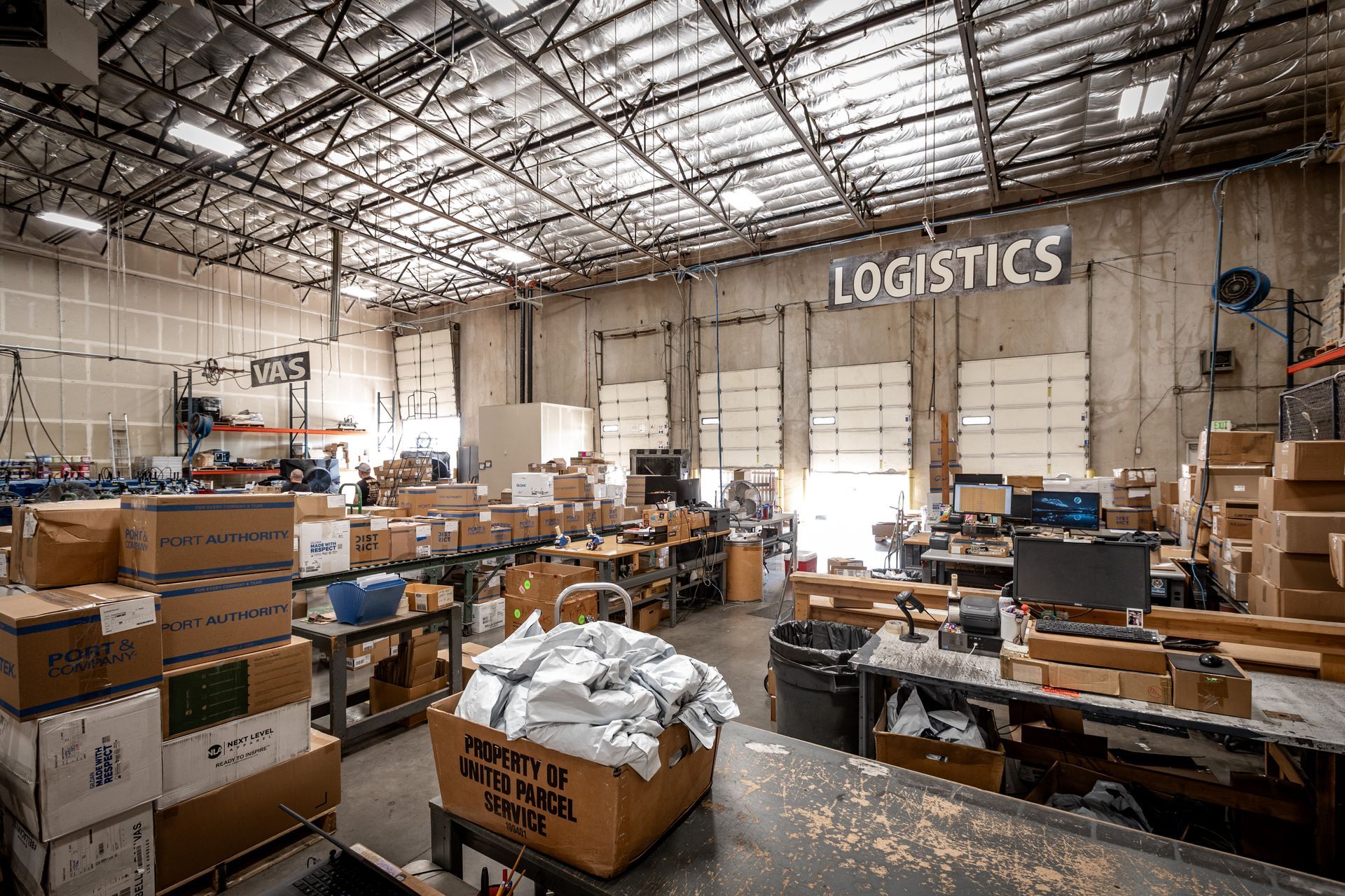 Warehouse interior with boxes, equipment, and the word