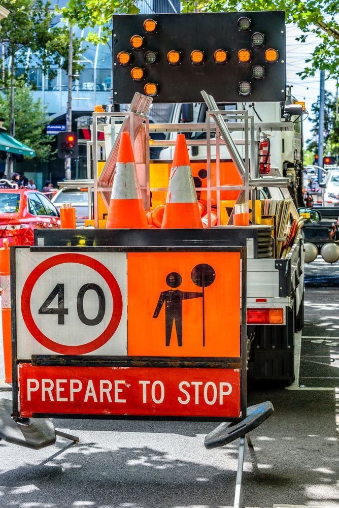 A Row Of Road Signs Against A Blue Sky With Clouds — RAG Traffic Management In Warrnambool, VIC