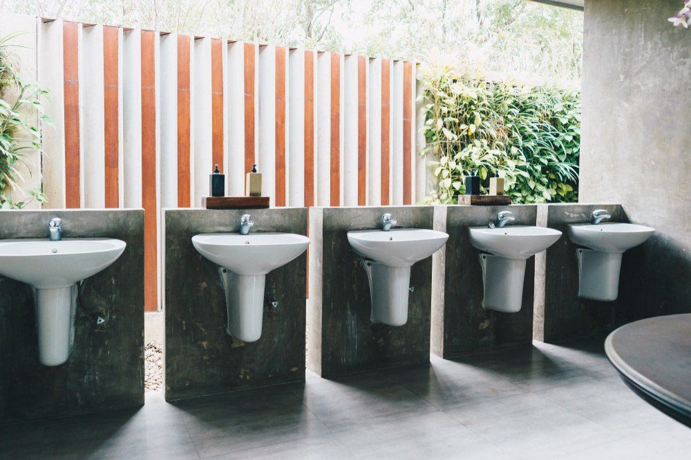Row Of Sinks In Commercial Bathroom — Plumbers in Harlaxton, QLD