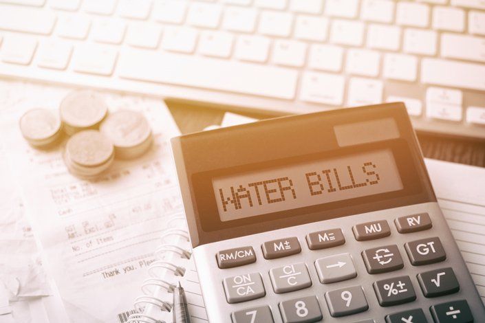 Calculator Next To Water Bills — Plumbers in Harlaxton, QLD