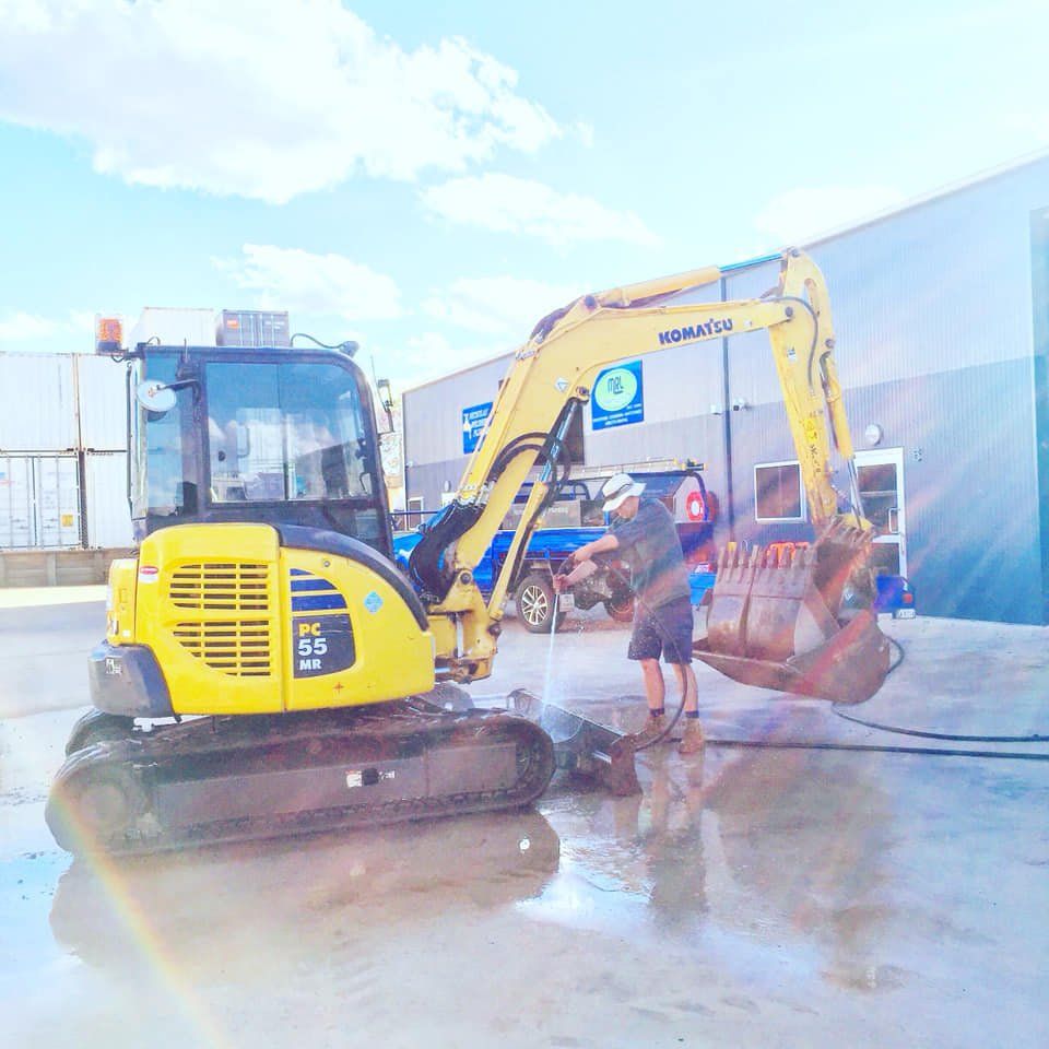 Excavator Being Cleaned — Plumbers in Toowoomba, QLD