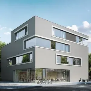 Moderno edificio grigio con ampie finestre. Il piano terra ha una vetrina e biciclette parcheggiate di fronte.