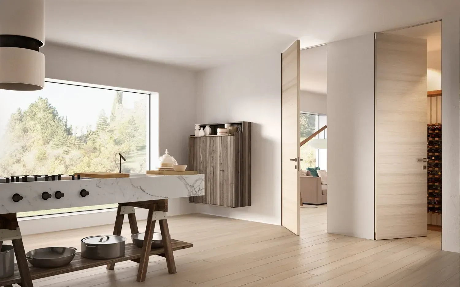 Cucina moderna con pavimenti in legno chiaro, ampia finestra e porte aperte che conducono ad altre stanze.