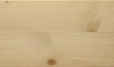 Primo piano delle venature del legno chiaro con nodi e linee visibili.