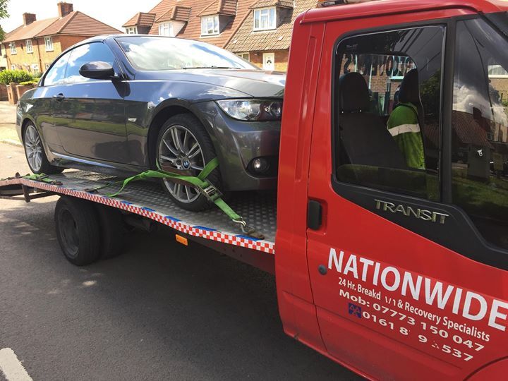 A.C Recovery's, 24 hour towing service in Barking and Dagenham, black car towed by red towing truck