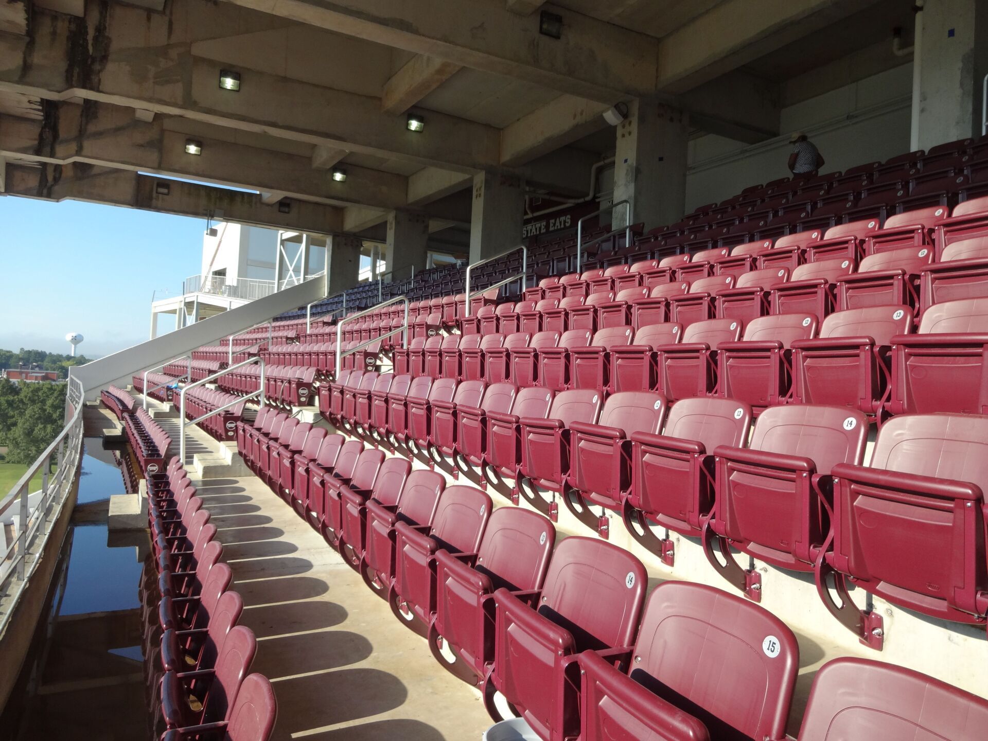 A college stadium filled with rows of maroon seats