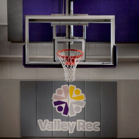 Basketball hoop and backboard above a ValleyRec sign in an indoor gym