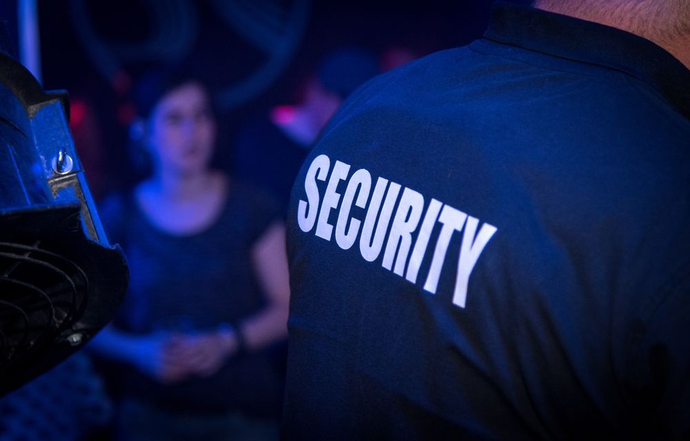 Security Guard in A Dark Club, Backs Turned — Safe Guard Squad in Lismore, NSW
