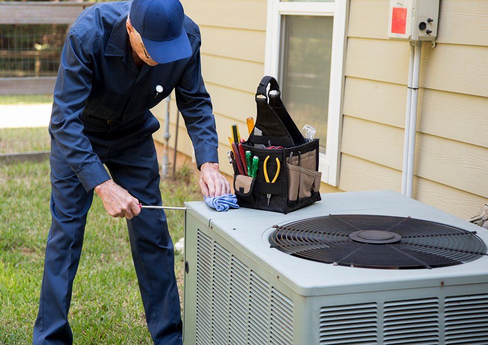 Technician With Air Conditioning Unit — Chicago, IL — HVAC Technical Institute