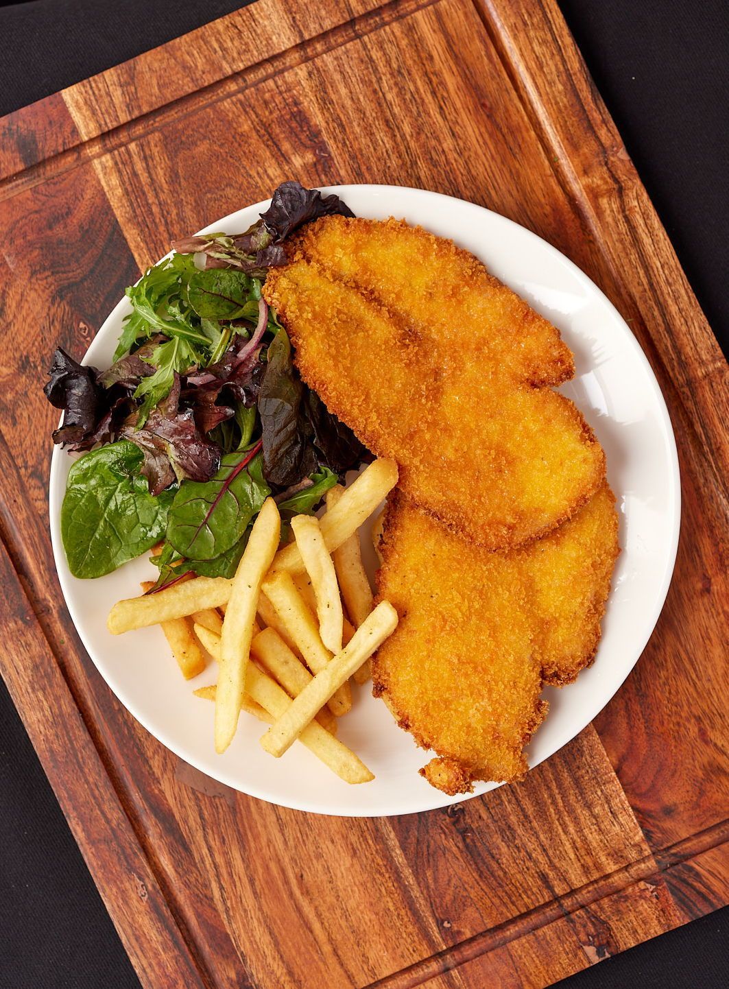 Chicken schnitzel with chips and salad