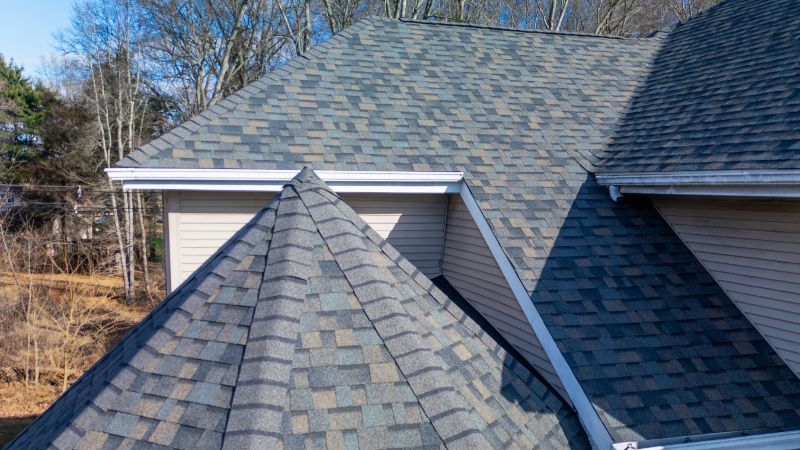 A close up of a roof of a house with a cone shaped roof.