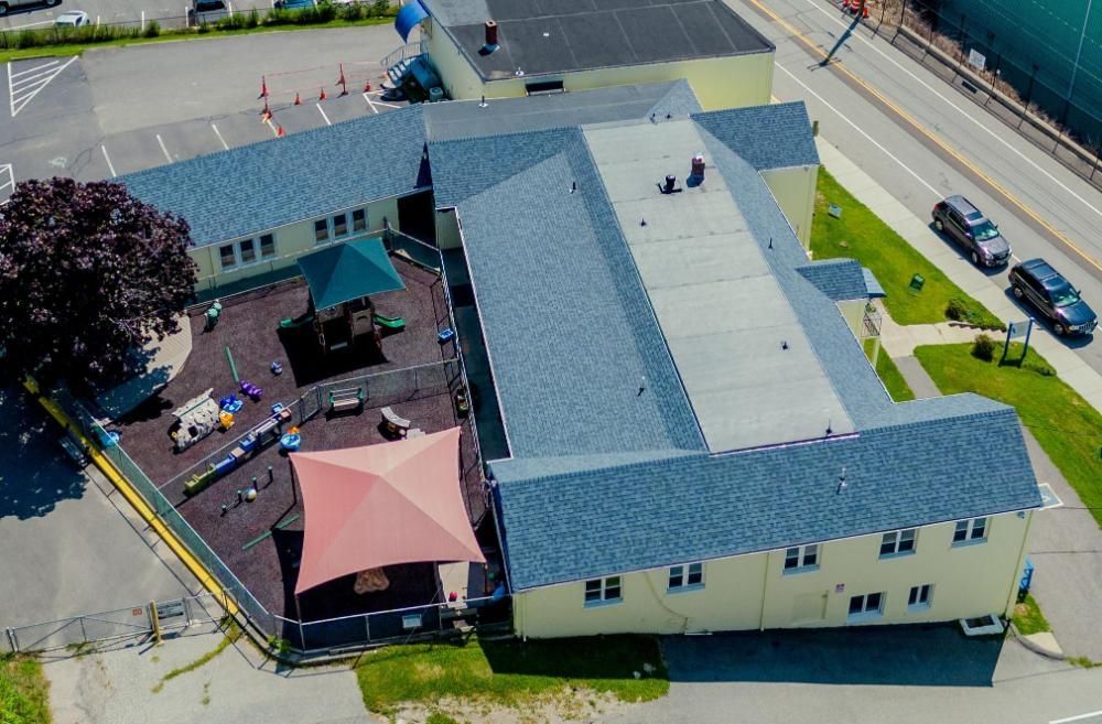 An aerial view of a large building with a playground in front of it