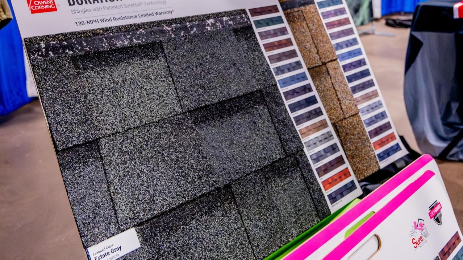 A display of a variety of roofing shingles in a box.