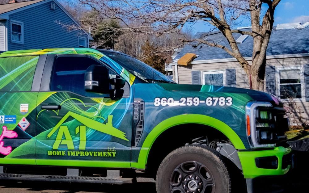 An A1 Home Improvement truck parked in front of a house.