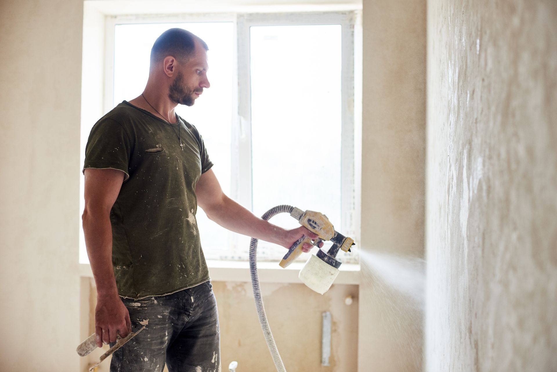 man using paint sprayer
