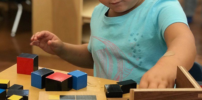 preschool aged child with binomial cube lesson