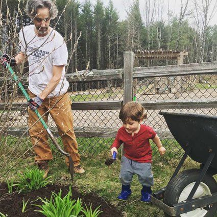 Toddler with parent, gardening