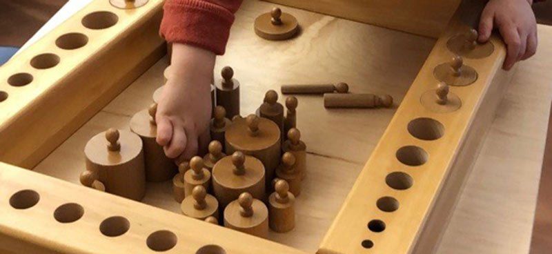 graduated knobbed cylinders lesson with small hands reaching for a cylinder