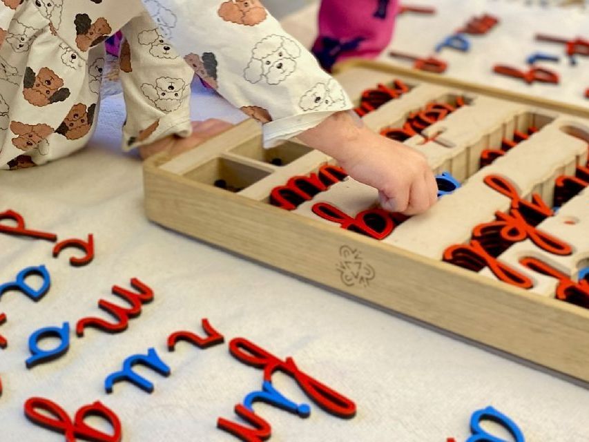 Image of a preschool aged child working with the moveable alphabet