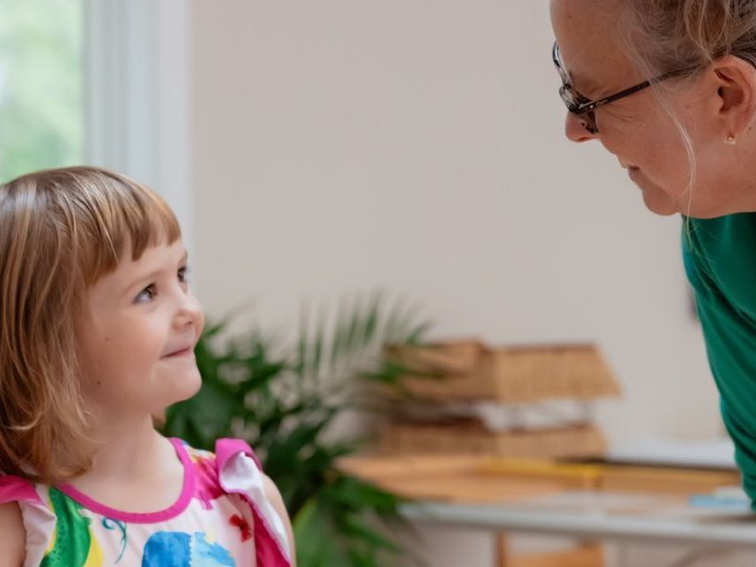 Image of a pre-school aged child talking with an adult