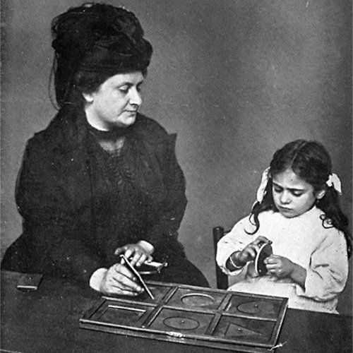 Black and white image of Dr. Montessori and child with insets lesson