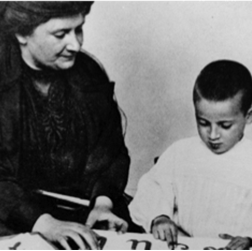 Dr. Montessori with child and sandpaper letters