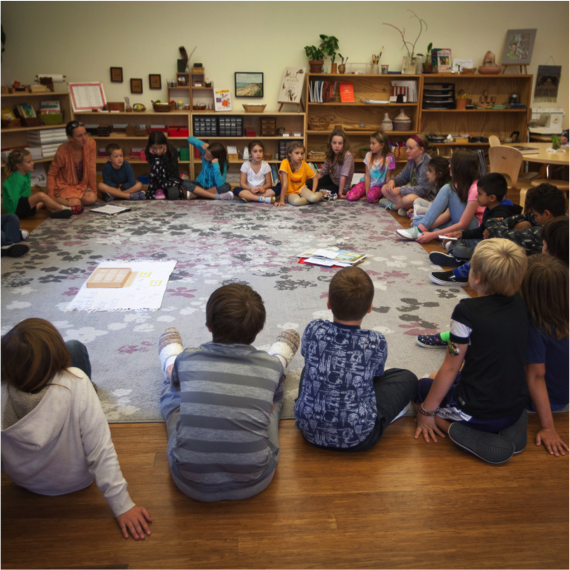 Elementary students in circle on rug for class meeting