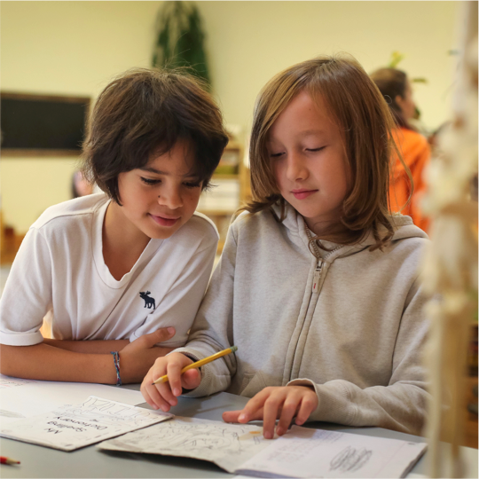 Two children working on lessons