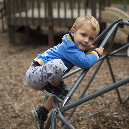 Toddler on climbing structure