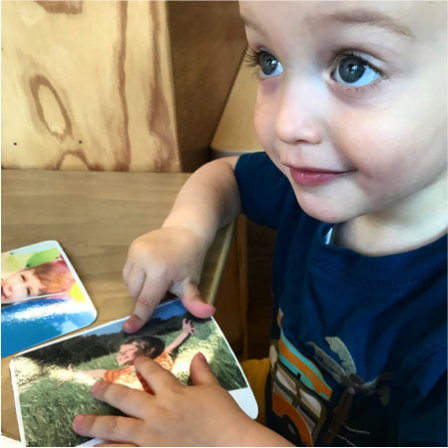 Toddler with image card