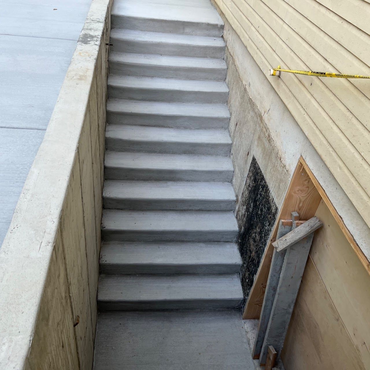 A set of concrete stairs leading up to a basement