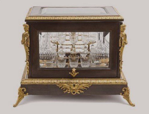 A wooden display case with a glass door