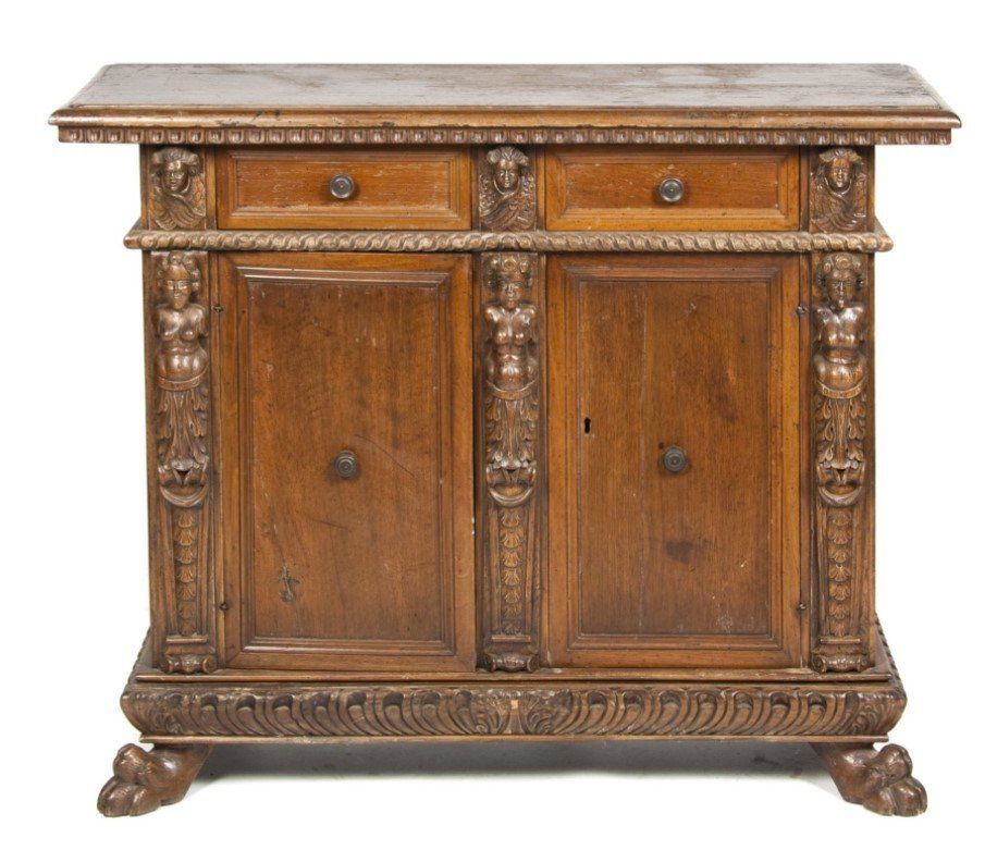 A carved wooden cabinet with two doors and two drawers